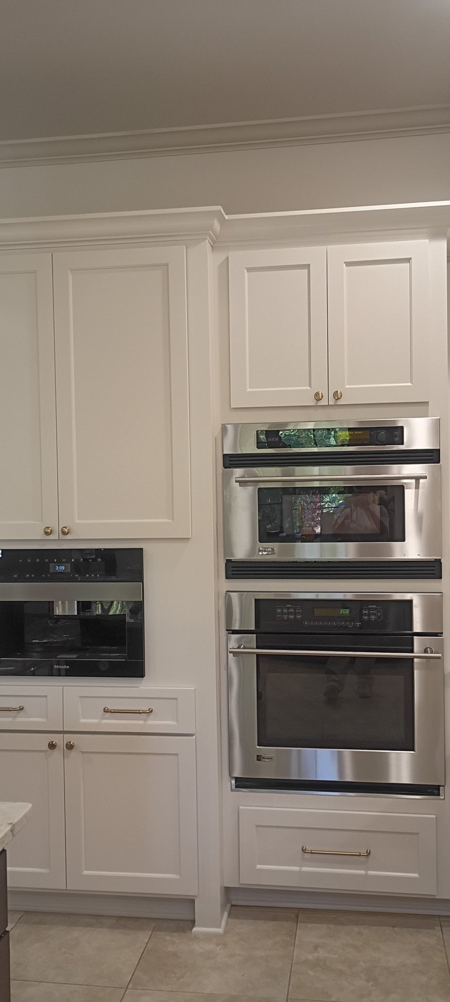 Tall refinished cabinetry housing the double ovens