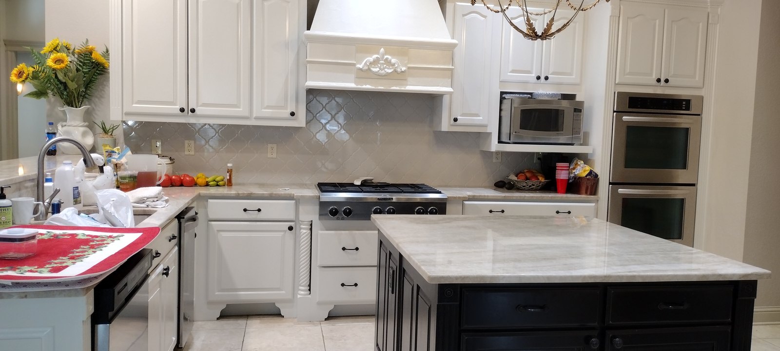 Full kitchen with refinished white cabinetry and island