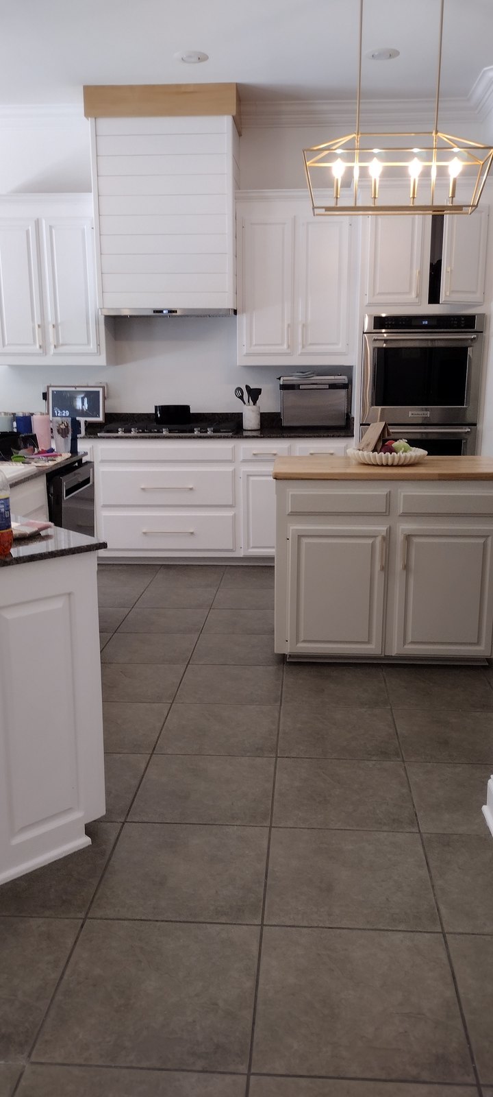 Refinished kitchen cabinetry under pendant lighting