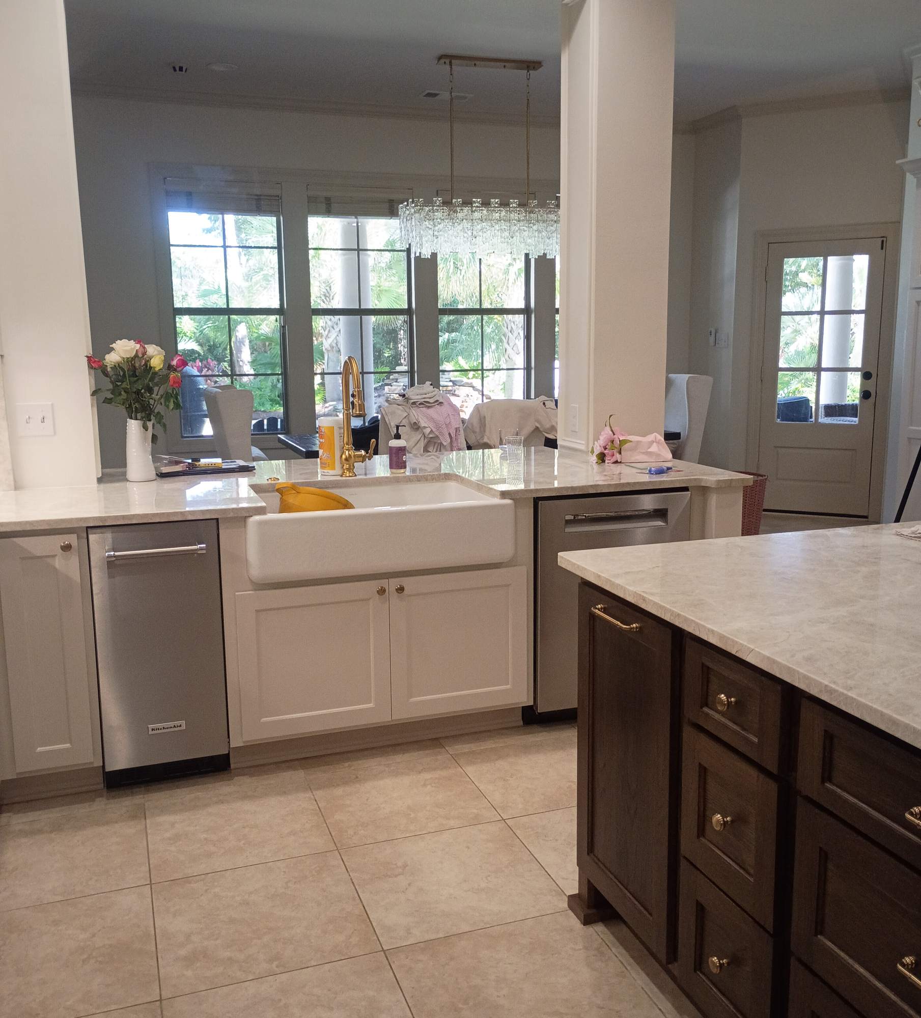 Refinished kitchen cabinetry with farmhouse sink and stained island