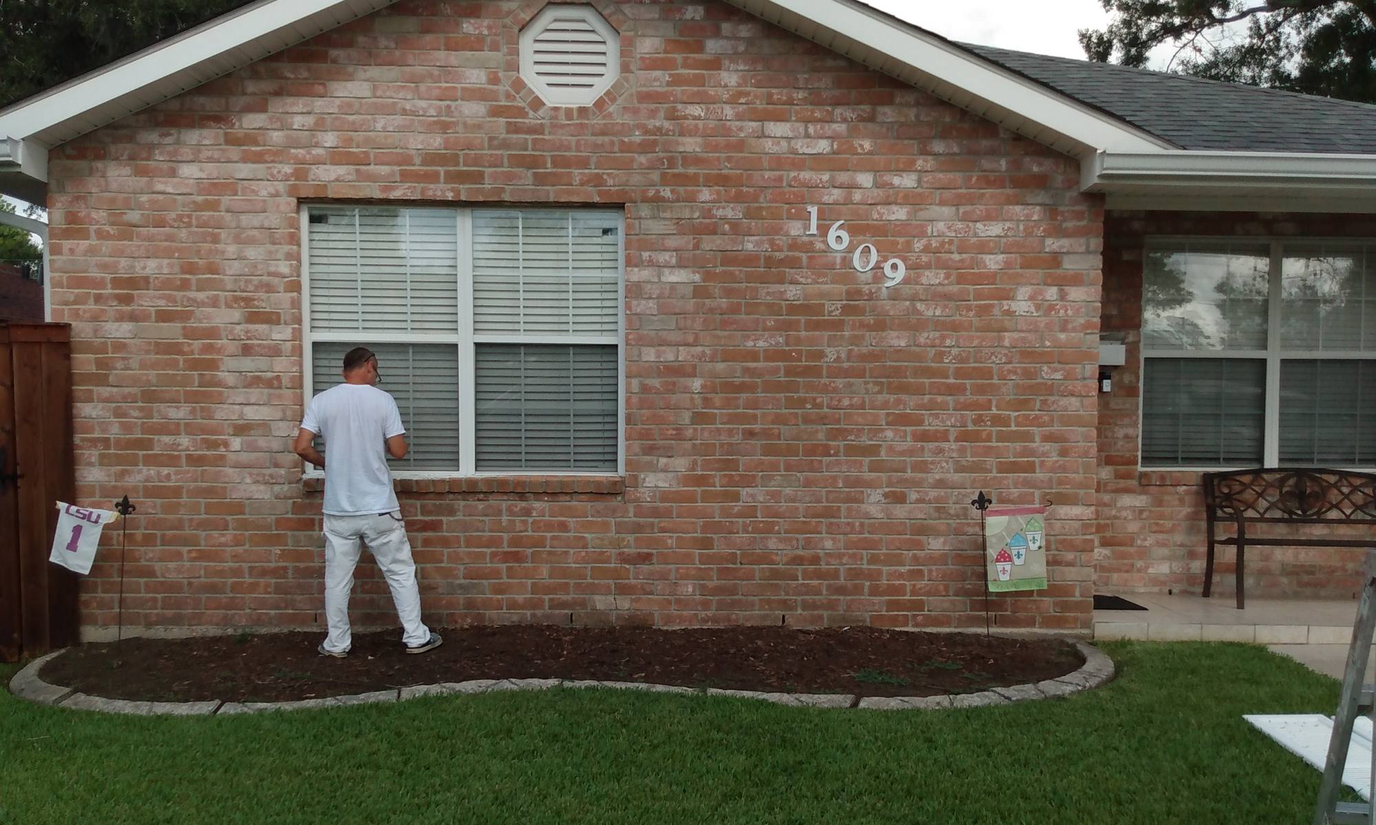 The same home before painting, unpainted red brick