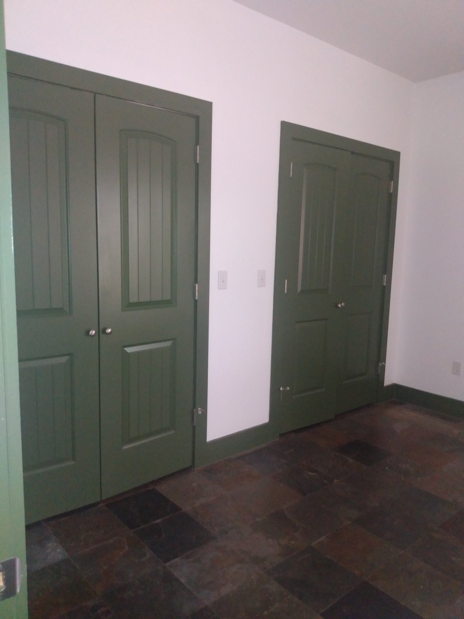 The same doors before painting, dark green with pale walls