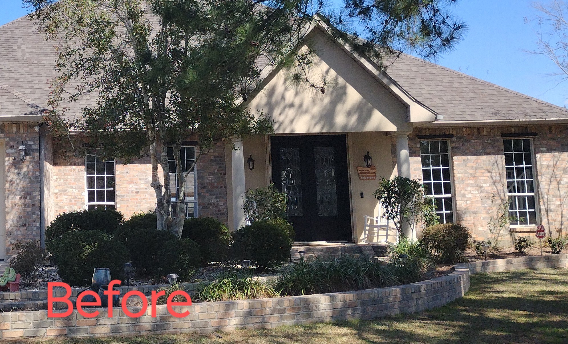 Home's exterior before painting, bare red brick